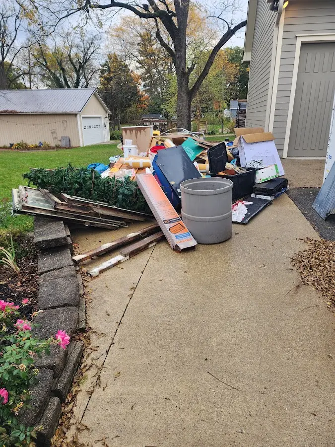 Dumpster being loaded with debris for Estate Cleanout Dumpster Rental in Harrington Park
